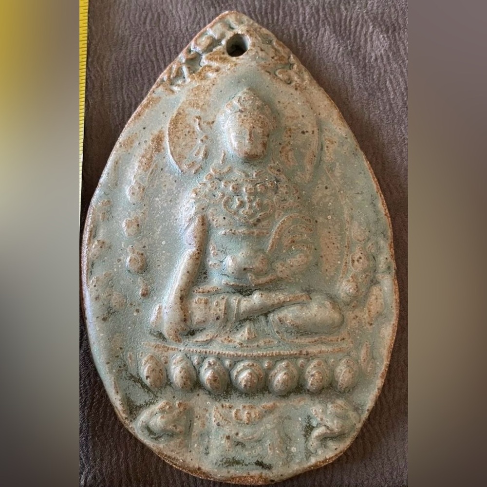 Hand made wall hanging ceramic Buddha.